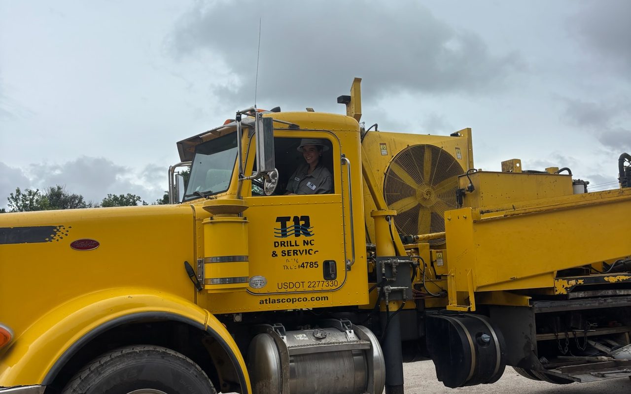 A TR Drilling crew member in the cab of the company drilling rig on a Hill Country job